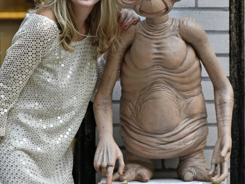 Frau posiert mit Statue von Alien E.T.