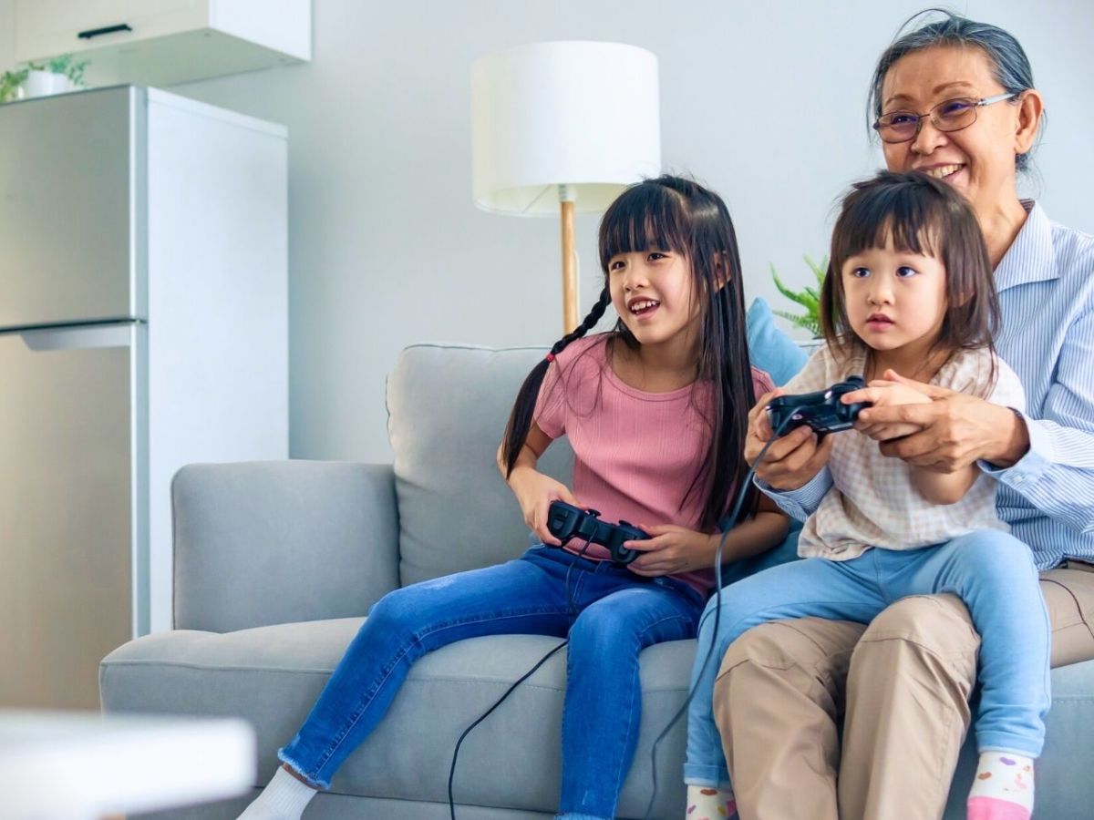 Oma spielt mit Enkelkindern Videospiele