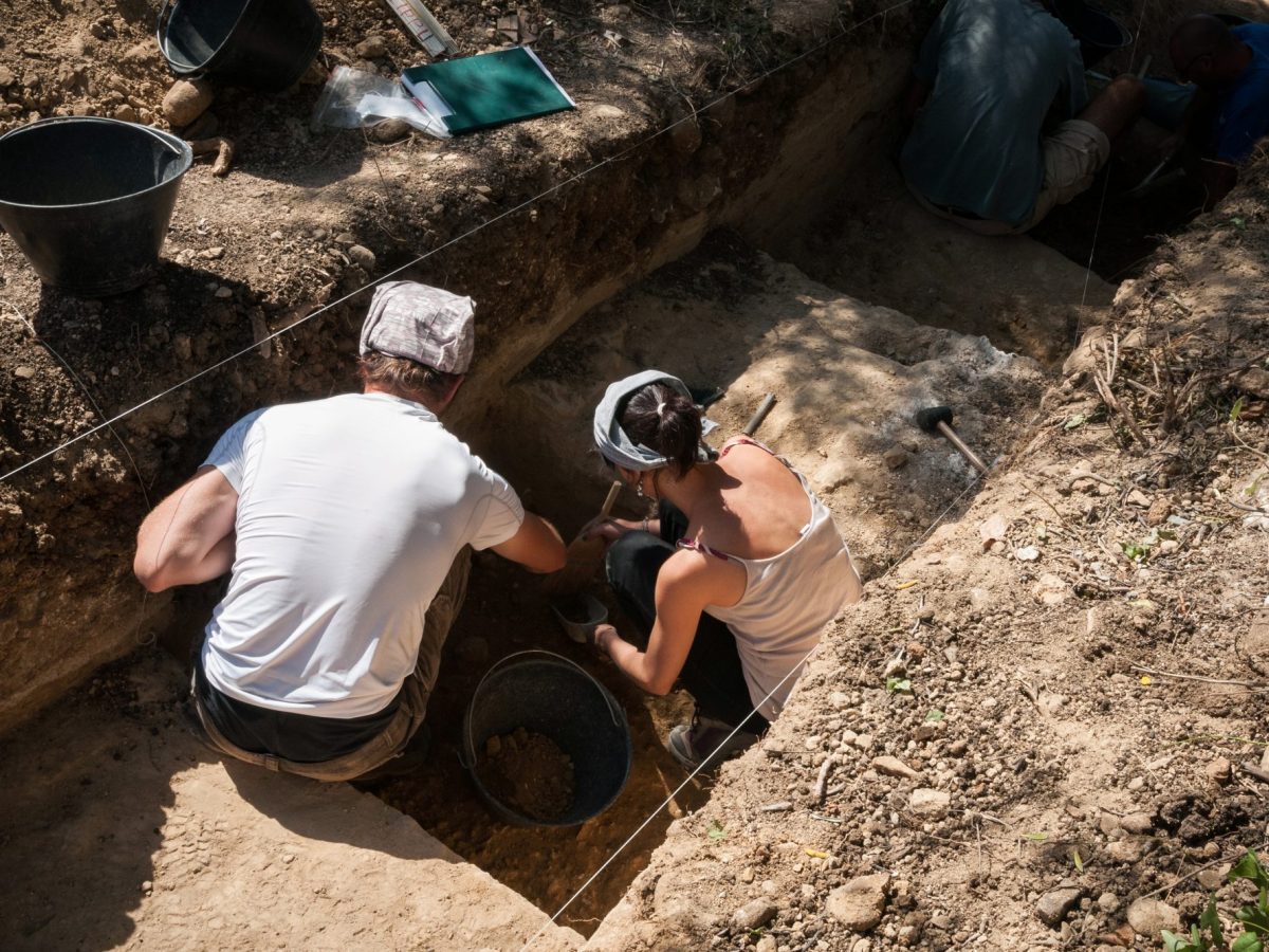 Zwei ArchÃ¤olog*innen graben an einem archÃ¤ologischen Fund.