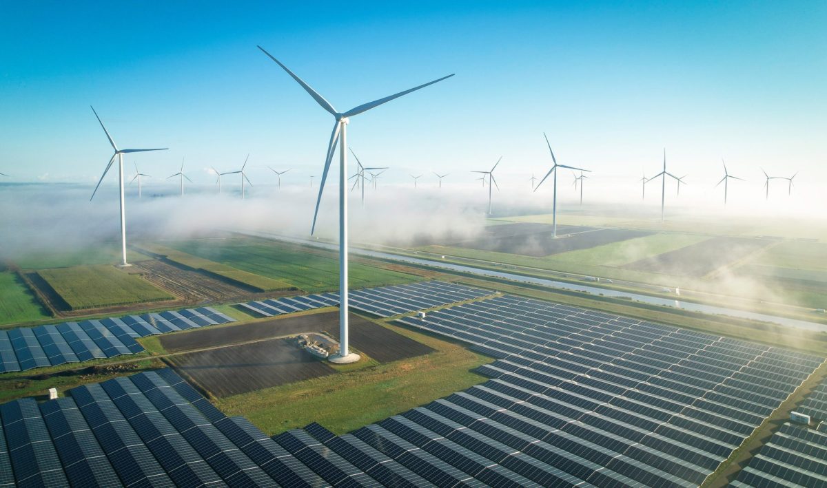 Solaranlage und Windkraftanlage auf einem Feld.