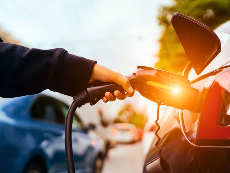 Person lÃ¤dt ein Elektroauto