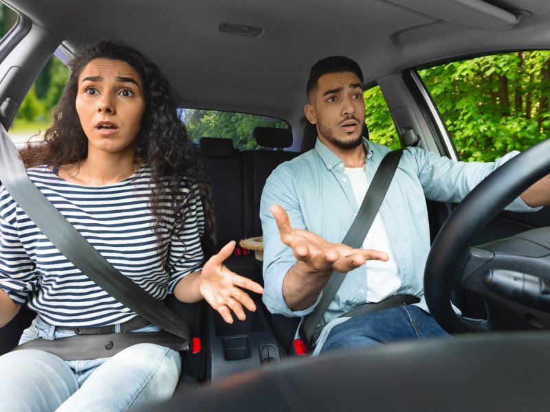 Verwirrtes junges Paar im Auto